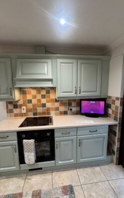 Light green painted wooden kitchen cabinets