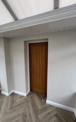 Painting in home extension with wooden door